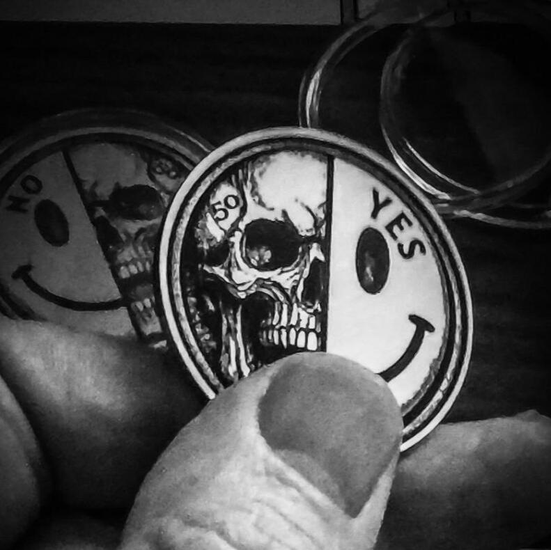 Laser-engraved metal coin using layered shading and detail to create a raised 3D-style effect.