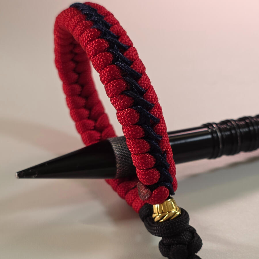 Clean Fishtail weave with contrasting stitched detail and a simple cord-and-loop finish.